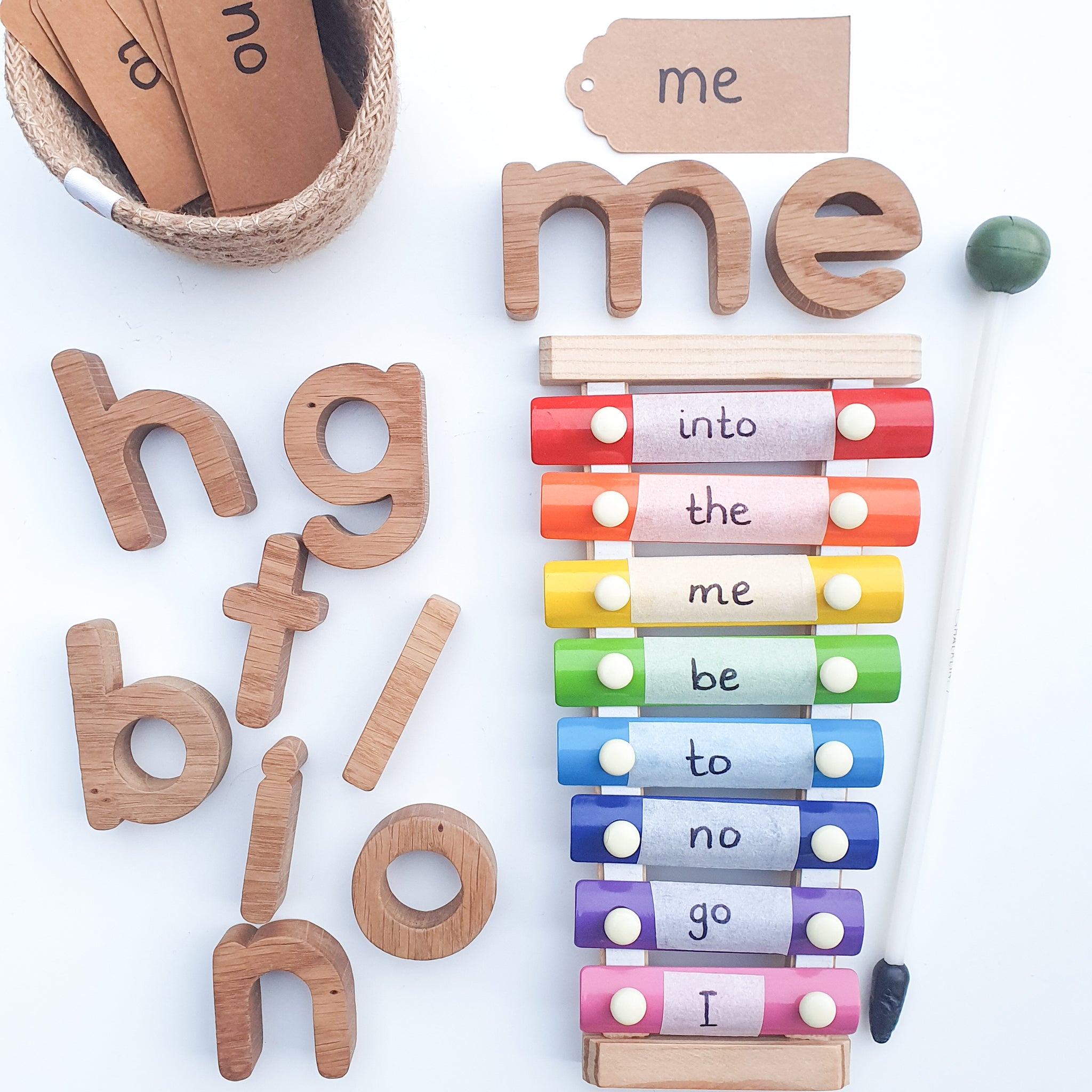 handmade wooden oak alphabet letters toy being used to learn phonics with the use of a xylophone.