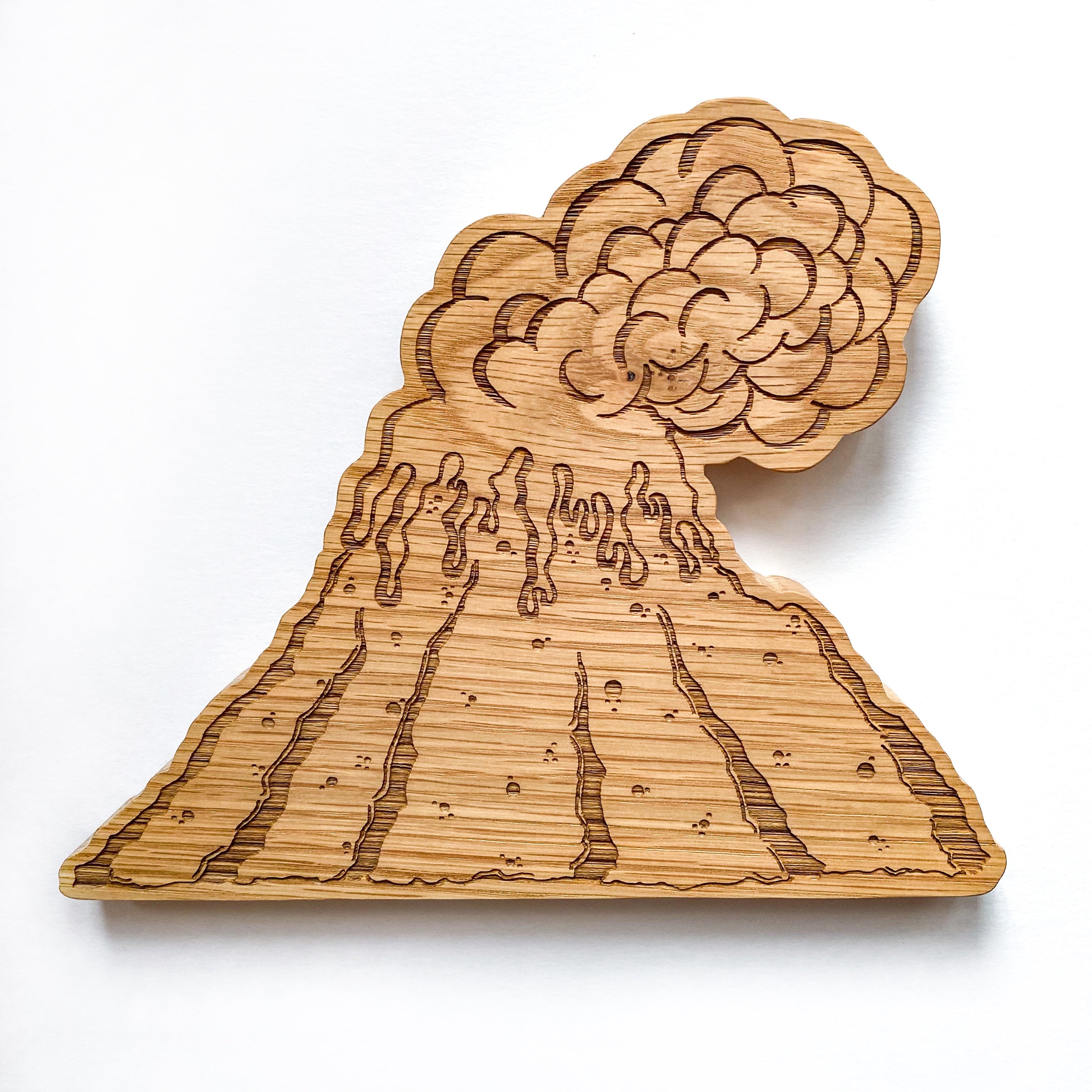 Wooden Oak lasered volcano with smoke cloud on a white background.